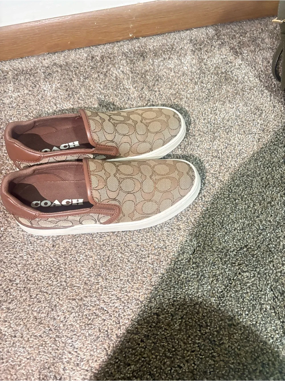 Coach women’s Brown Signature Slip-On Sneakers
